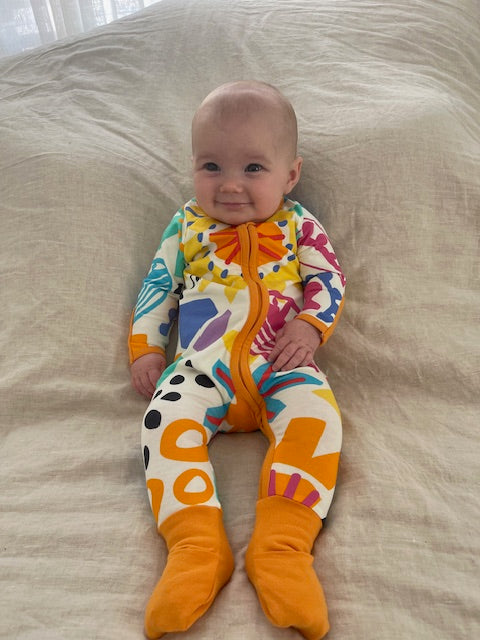 multi coloured long sleeve baby onesie with fold over hand and foot cuffs in unisex design