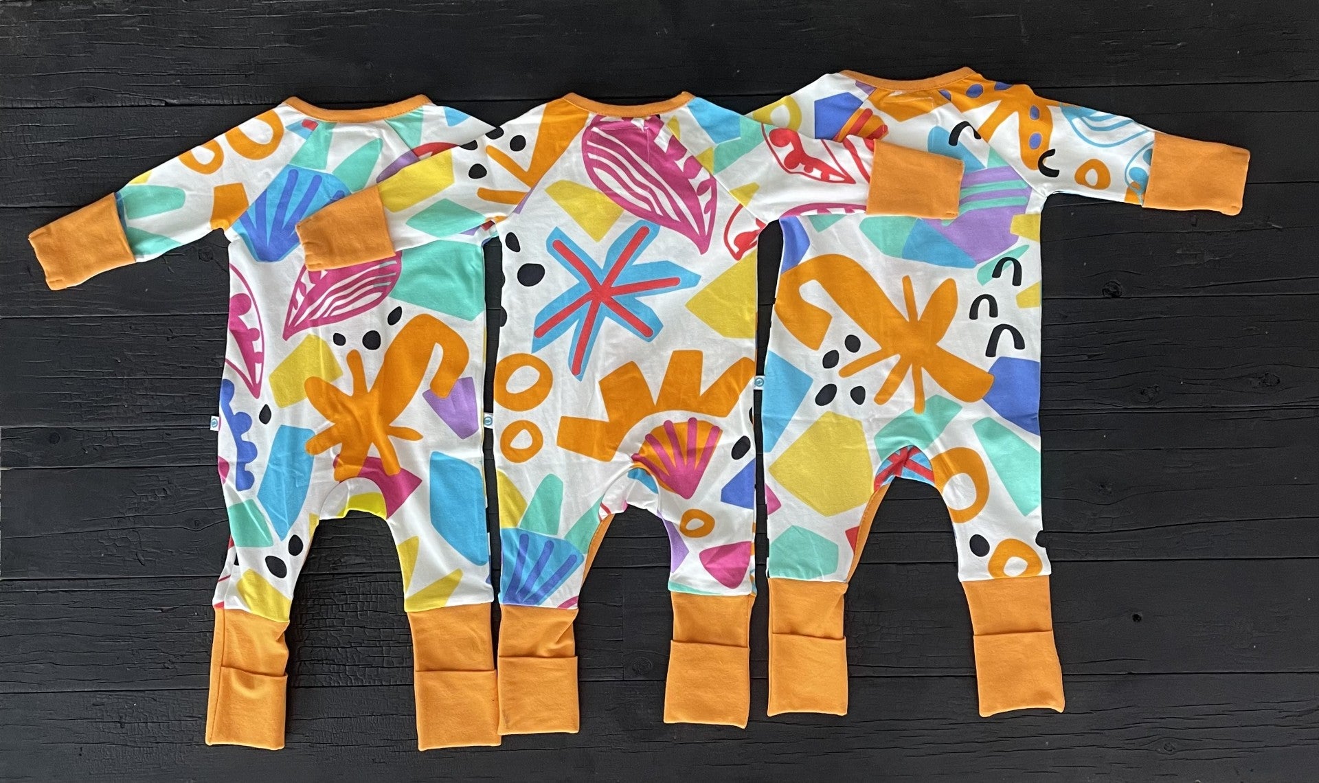 3 x multi coloured long sleeve baby onesie with fold over hand and foot cuffs in unisex design