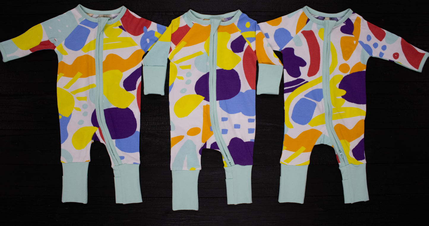 3 x Baby onesies lying flat to show different design on each