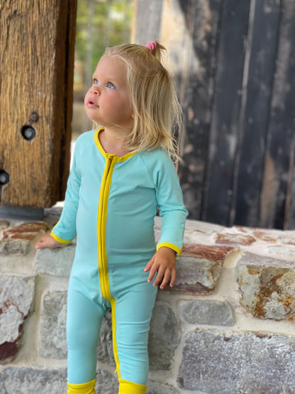 solid teal long sleeve baby onesie with dandelion trim with fold over hand & foot cuffs and double zip